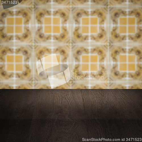 Image of Wood table top and blur vintage ceramic tile pattern wall