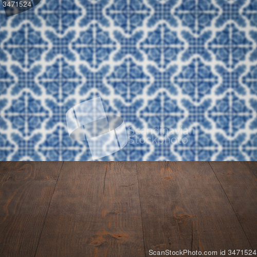Image of Wood table top and blur vintage ceramic tile pattern wall
