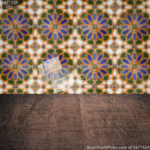 Image of Wood table top and blur vintage ceramic tile pattern wall