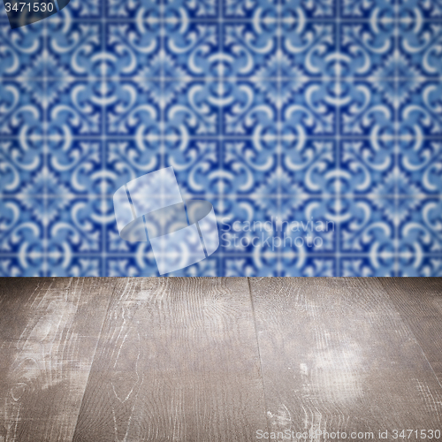 Image of Wood table top and blur vintage ceramic tile pattern wall