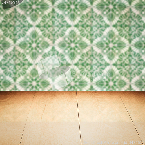 Image of Wood table top and blur vintage ceramic tile pattern wall