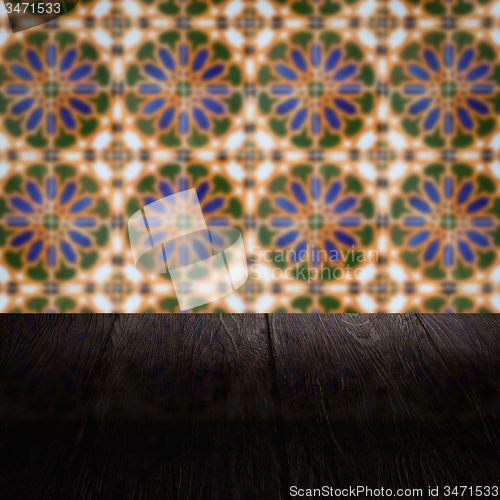 Image of Wood table top and blur vintage ceramic tile pattern wall