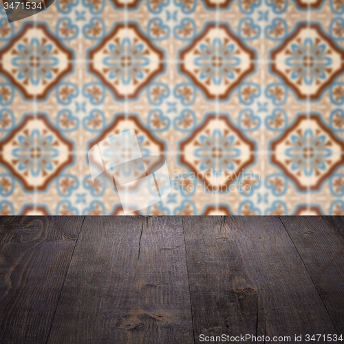 Image of Wood table top and blur vintage ceramic tile pattern wall