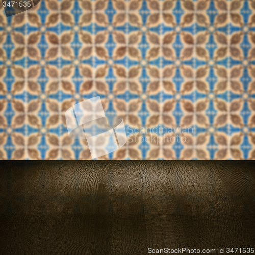 Image of Wood table top and blur vintage ceramic tile pattern wall