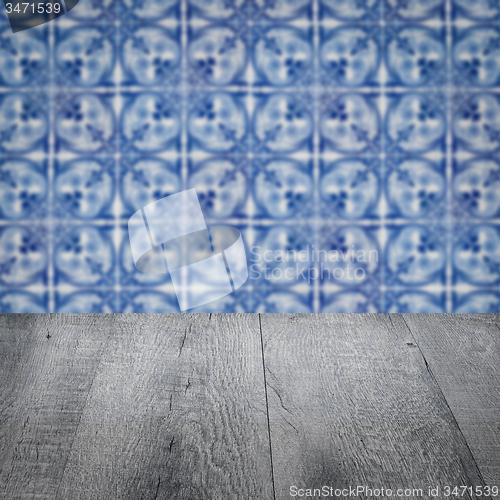 Image of Wood table top and blur vintage ceramic tile pattern wall
