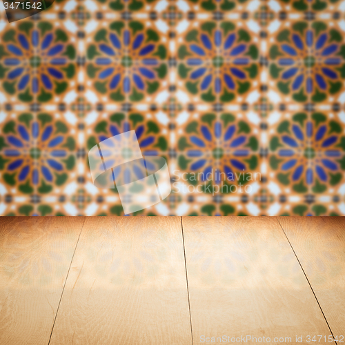 Image of Wood table top and blur vintage ceramic tile pattern wall