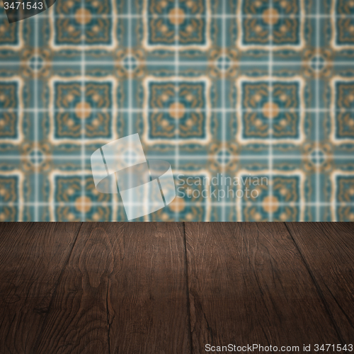 Image of Wood table top and blur vintage ceramic tile pattern wall