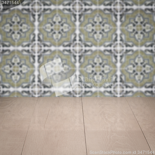 Image of Wood table top and blur vintage ceramic tile pattern wall