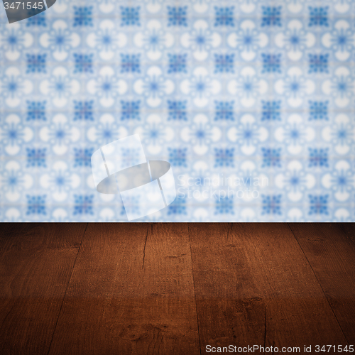 Image of Wood table top and blur vintage ceramic tile pattern wall