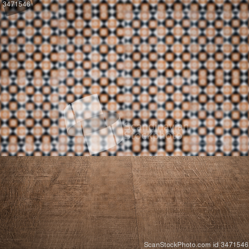 Image of Wood table top and blur vintage ceramic tile pattern wall