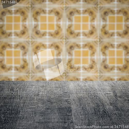 Image of Wood table top and blur vintage ceramic tile pattern wall