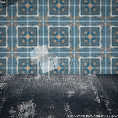 Image of Wood table top and blur vintage ceramic tile pattern wall