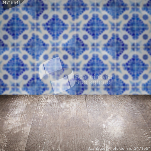 Image of Wood table top and blur vintage ceramic tile pattern wall