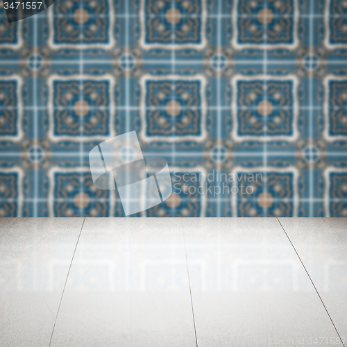 Image of Wood table top and blur vintage ceramic tile pattern wall