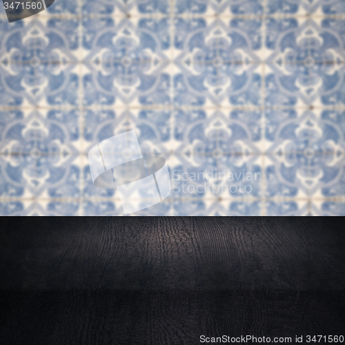 Image of Wood table top and blur vintage ceramic tile pattern wall