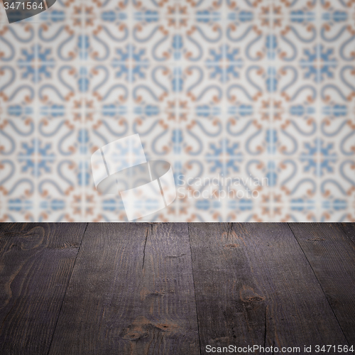 Image of Wood table top and blur vintage ceramic tile pattern wall