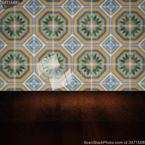 Image of Wood table top and blur vintage ceramic tile pattern wall