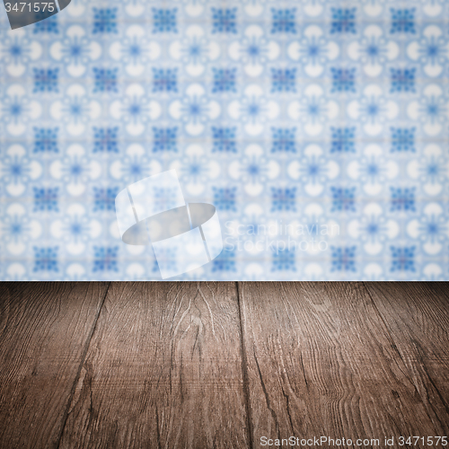 Image of Wood table top and blur vintage ceramic tile pattern wall