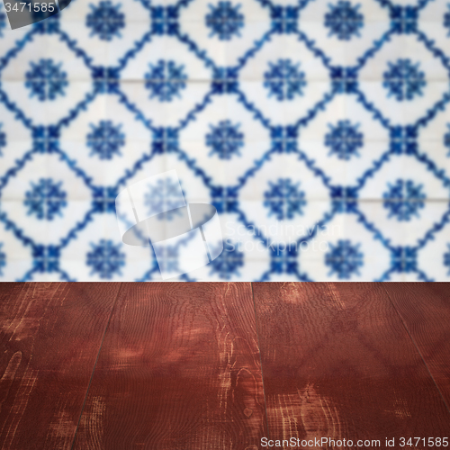 Image of Wood table top and blur vintage ceramic tile pattern wall