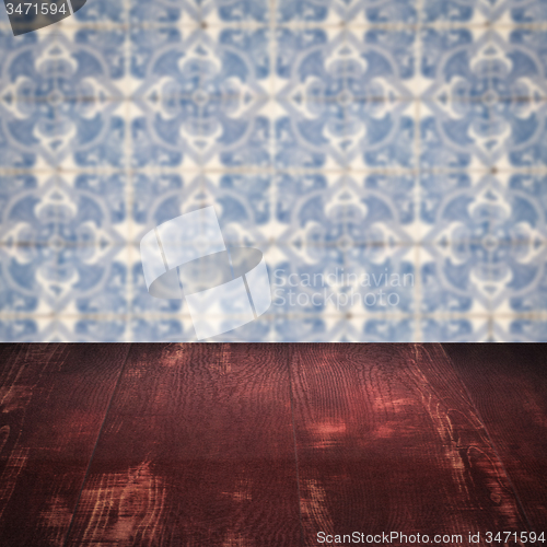 Image of Wood table top and blur vintage ceramic tile pattern wall