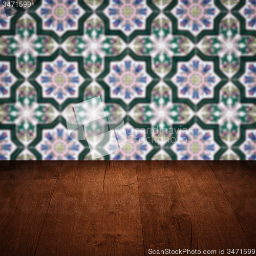 Image of Wood table top and blur vintage ceramic tile pattern wall