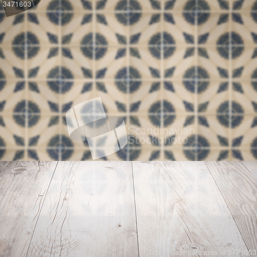 Image of Wood table top and blur vintage ceramic tile pattern wall