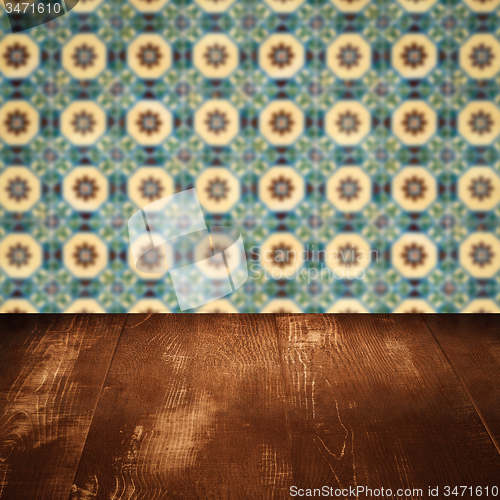 Image of Wood table top and blur vintage ceramic tile pattern wall