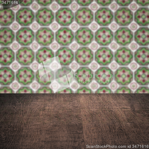 Image of Wood table top and blur vintage ceramic tile pattern wall