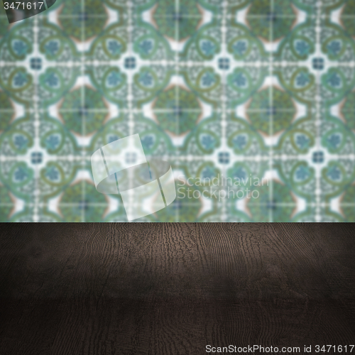 Image of Wood table top and blur vintage ceramic tile pattern wall