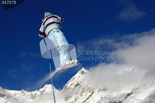 Image of Snowboarder jumping high in the air