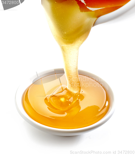 Image of honey pouring into bowl