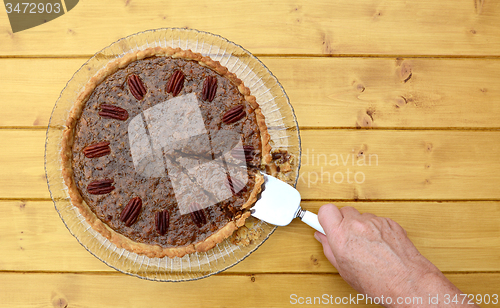 Image of Woman serves a slice of pecan pie