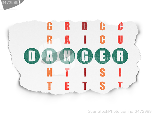Image of Safety concept: word Danger in solving Crossword Puzzle