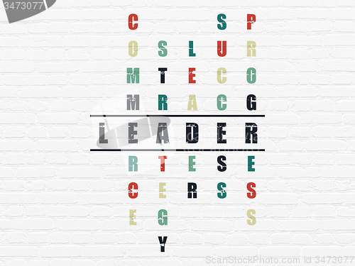 Image of Finance concept: word Leader in solving Crossword Puzzle
