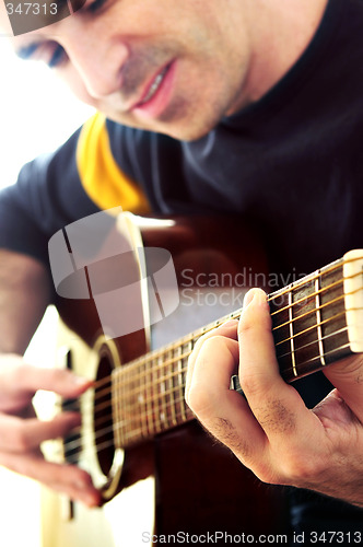 Image of Man playing a guitar