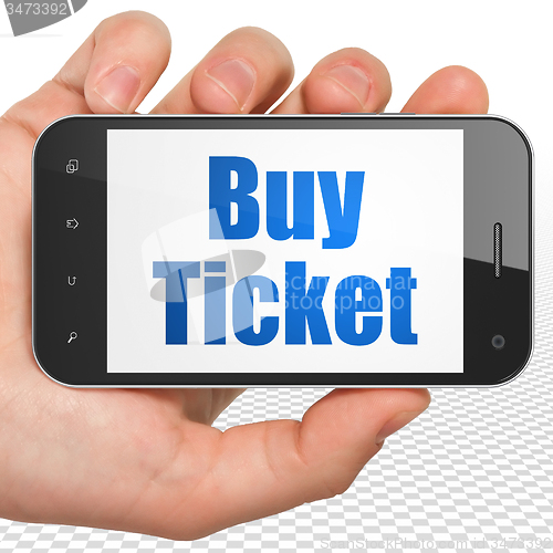 Image of Vacation concept: Hand Holding Smartphone with Buy Ticket on display