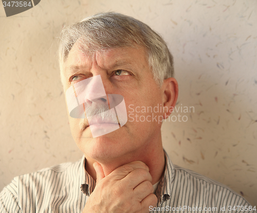 Image of senior man with throat pain