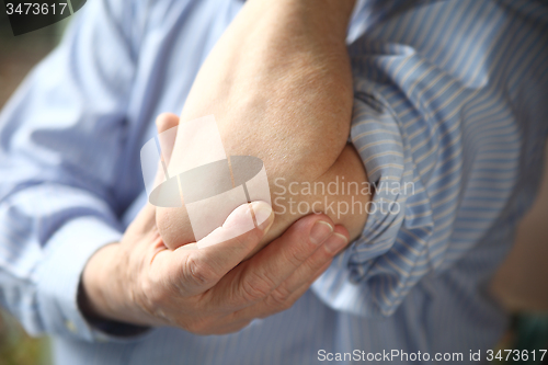 Image of businessman with sore elbow