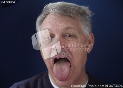 Image of man showing his tongue  