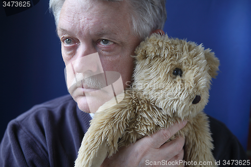 Image of senior holding teddy bear	