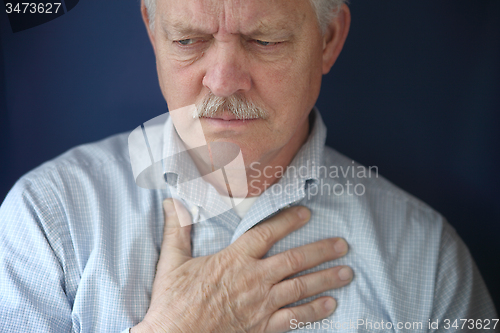 Image of older man feeling pain in chest  