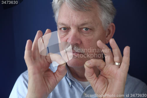 Image of American businessman with double okay gestures 