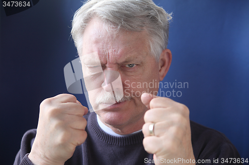 Image of hostile and combative senior man