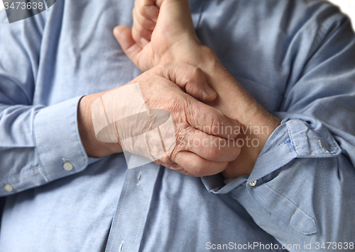 Image of businessman with an itchy arm