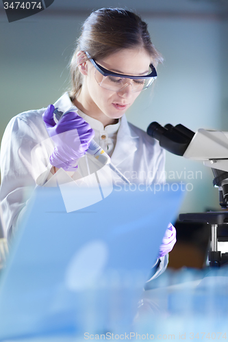 Image of Portrait of a helth care professional microscoping.