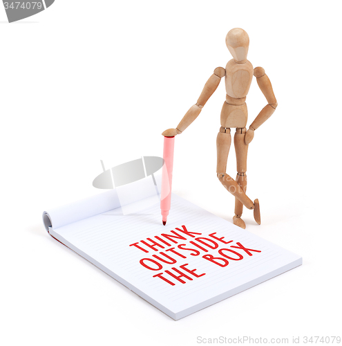 Image of Wooden mannequin writing - Think outside the box