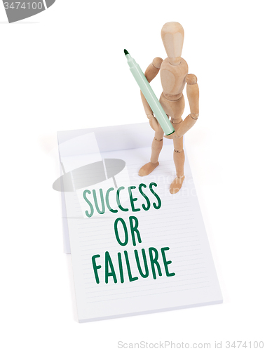 Image of Wooden mannequin writing - Success or failure