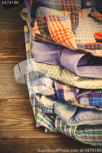 Image of stack of bright colorful shirts