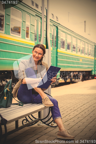 Image of smiling woman is planning railway retro-travel