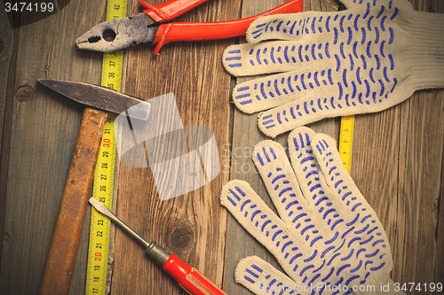 Image of old locksmith tools, work gloves and measuring tape